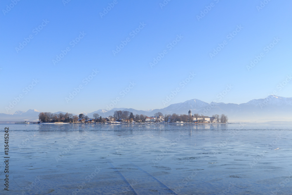 Island Fraueninsel on partly frozen Lake Chiemsee in Bavaria, Germany, on a cold winter day