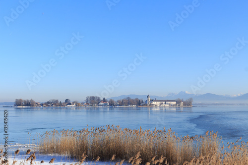 Island Fraueninsel on partly frozen Lake Chiemsee in Bavaria, Germany, on a cold winter day