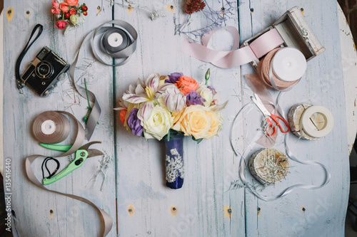 Little wedding bouquet with dark blue riibon lies on florist's w photo