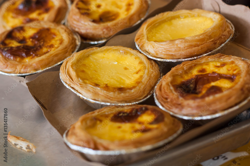 Egg tart or portuguese egg tart on recycled paper. Egg tart or portuguese egg tart on recycled paper.