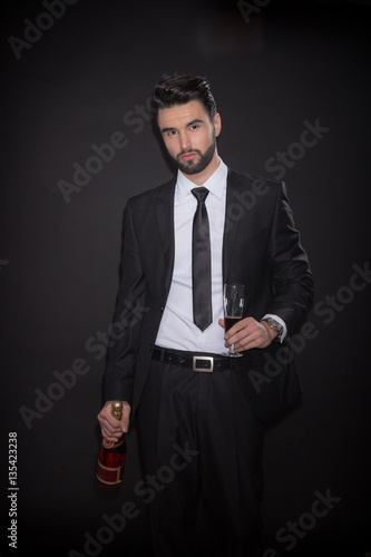 young man bottle alcohol glass wine suit elegant