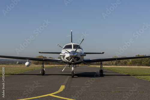 Private small single turboprop aircraft on airport runway photo