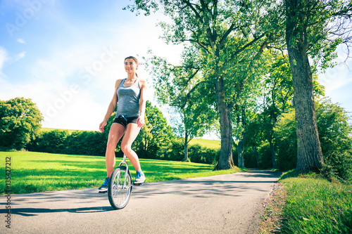 Young Woman Riding Her Unicycle photo