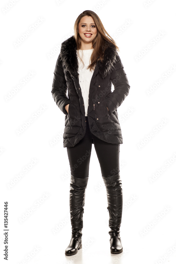 young woman in winter clothes on white background