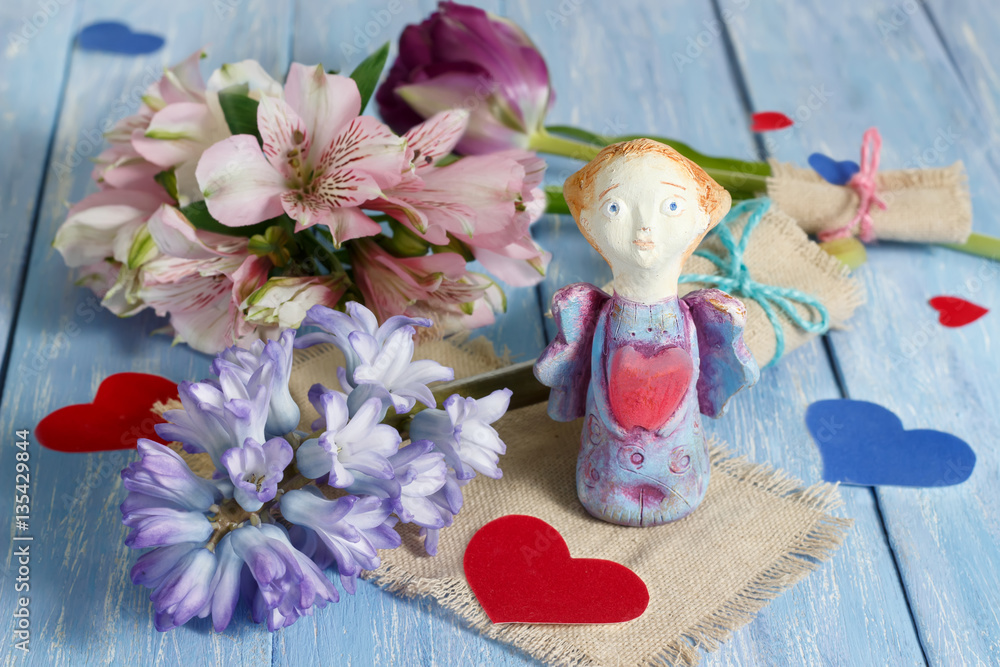Valentine day greeting card with handmade clay angel and hearts. Valentine's day, wedding or birthday concept. Selective focus.