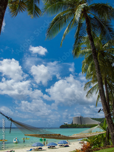 Hammock on the beach and blue ocean under the blue sky in tropical island (Guam)　南の島（グアム）の青空と海とハンモックとヤシの木