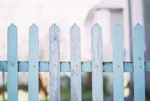 Old wooden blue fence in the suburban area