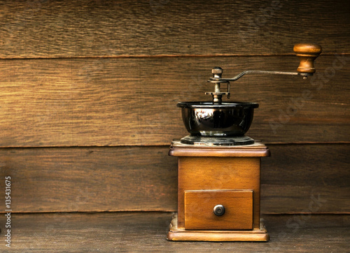 Vintage Coffee grinder on wood background.