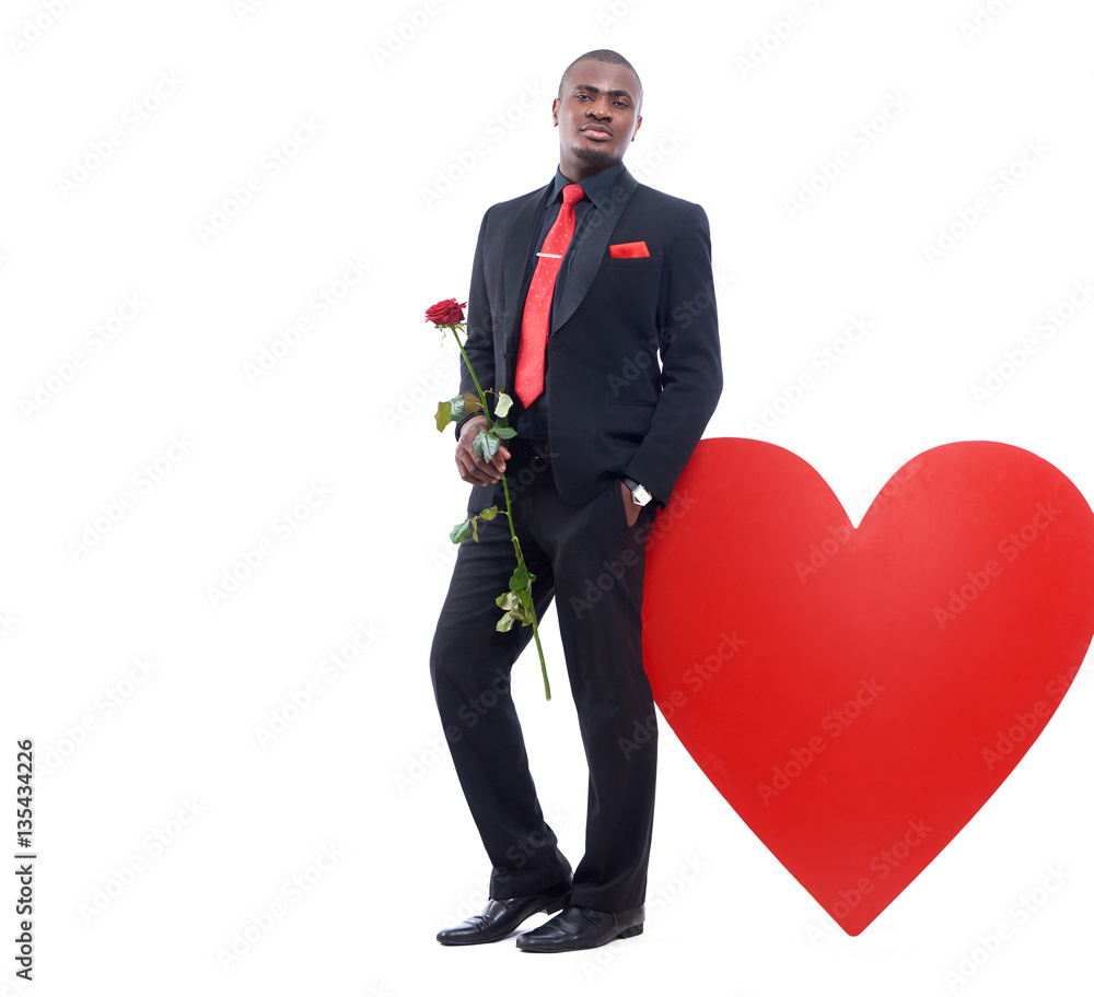 Man holding red rose and posing at studio. Man holding red rose and posing at studio.