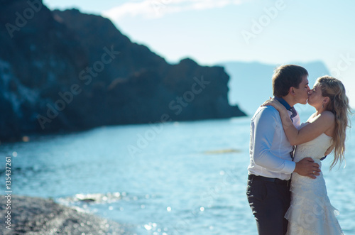 Romantic couple having fun on the beach. Young  in love, Attractive man and woman enjoying  evening  the , Holding hands watching the sunset