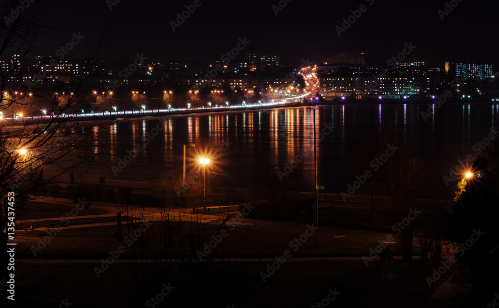Panorama of night city lights and reflections on lake at Ternopi