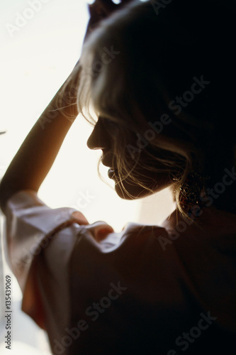 Silhouette of stunning blonde looking over her shoulder while sh