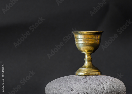 Fotografie Old chalice on stone