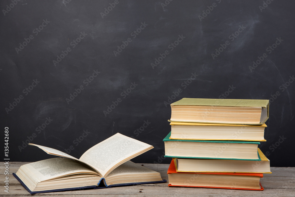 Education concept - books on the desk in the auditorium Education concept - books on the desk in the auditorium