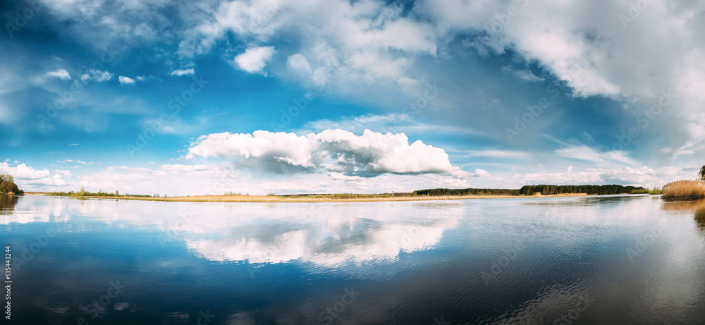 River Or Lake Landscape With Reflections Of Cloudy Sky In Water.