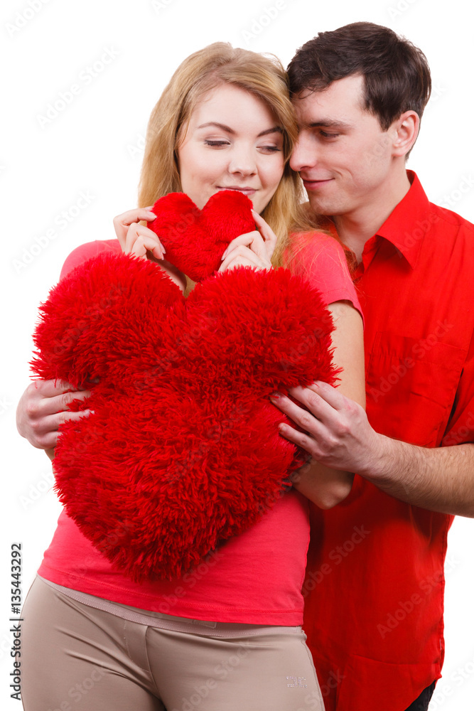 Couple holds red heart shaped pillows love symbol Couple holds red heart shaped pillows love symbol