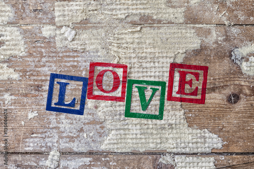 Word “LOVE” on old wood background. Word “LOVE” on old wood background.