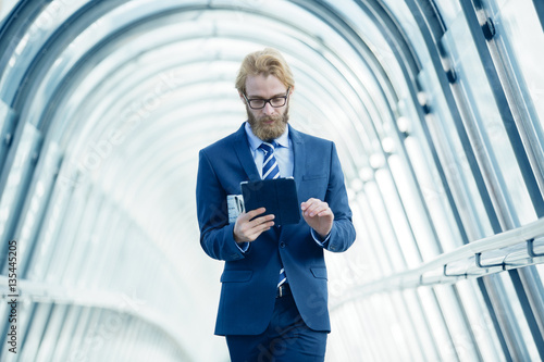 Businessman using a Tablet in fiancial district photo