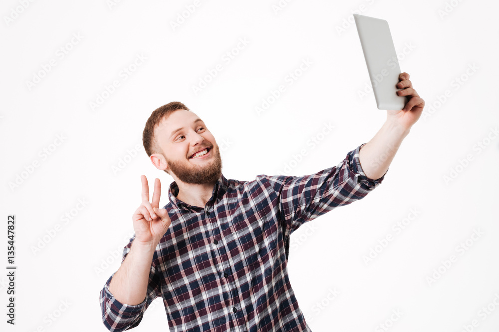 Man in shirt making selfie on tablet computer Man in shirt making selfie on tablet computer