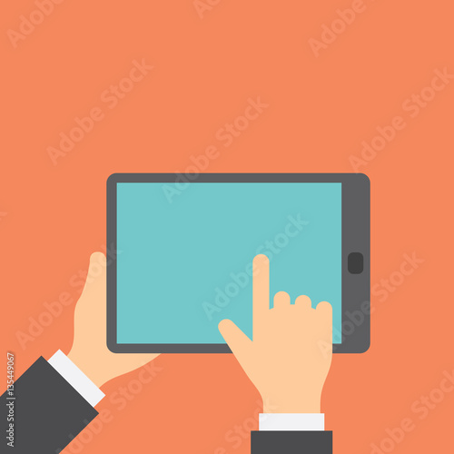 Finger clicks on tablet display with touch screen.