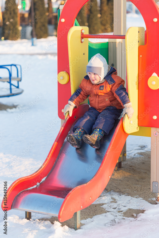 Gomel, Belarus - 31 January 2017: A boy plays on the playground in the winter time.