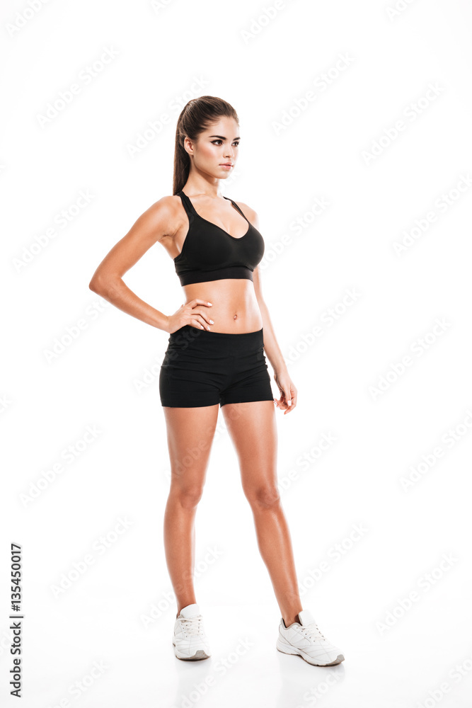Full length of pretty young sportswoman in black sportswear Full length of pretty young sportswoman in black sportswear