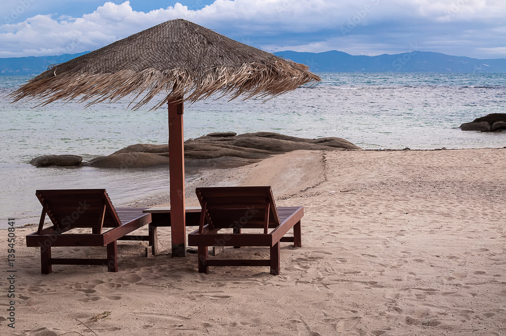 Vacation holidays background wallpaper - two beach lounge chairs under tent on beach. Vacation holidays background wallpaper - two beach lounge chairs under tent on beach.