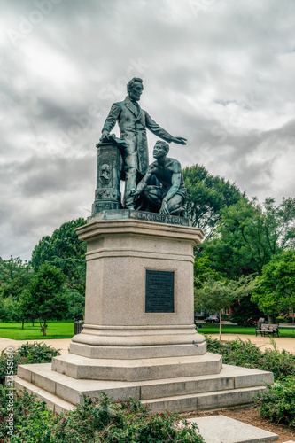 The bronze statue features President Lincoln standing with his left arm out-stretched over a crouching freed slave. Washington DC.
