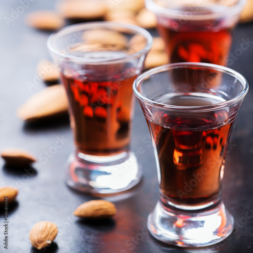 Almond liquor amaretto on a grunge black table