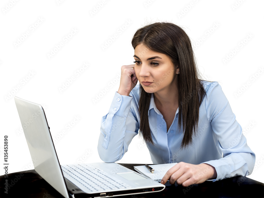 A young woman stares at a laptop screen. White isolated background. A young woman stares at a laptop screen. White isolated background.