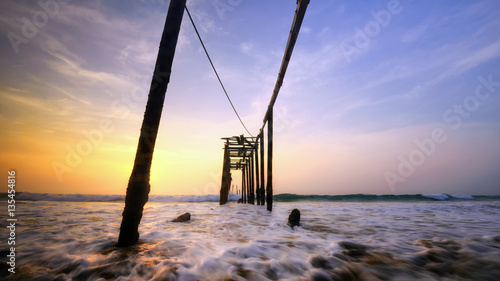 Old wooden bridge at the beach , Concept Feel lonely tone on beach.