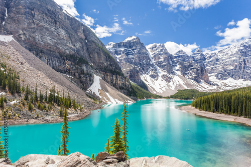 Fototapeta Naklejka Na Ścianę i Meble -  Moraine lake in Banff National Park, Canadian Rockies, Canada. Sunny summer day with amazing blue sky. Majestic mountains in the background. Clear turquoise blue water.