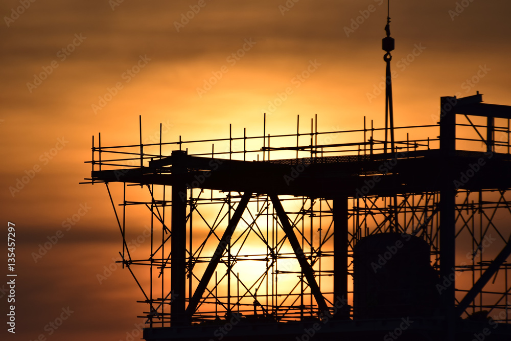 Silhouette structural steel beam build large residential buildings at construction site .
