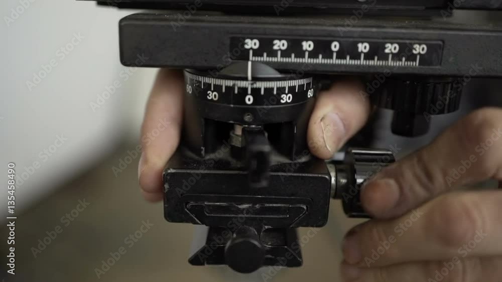 Man adjusts the tripod. Close-up of hands Man adjusts the tripod. Close-up of hands