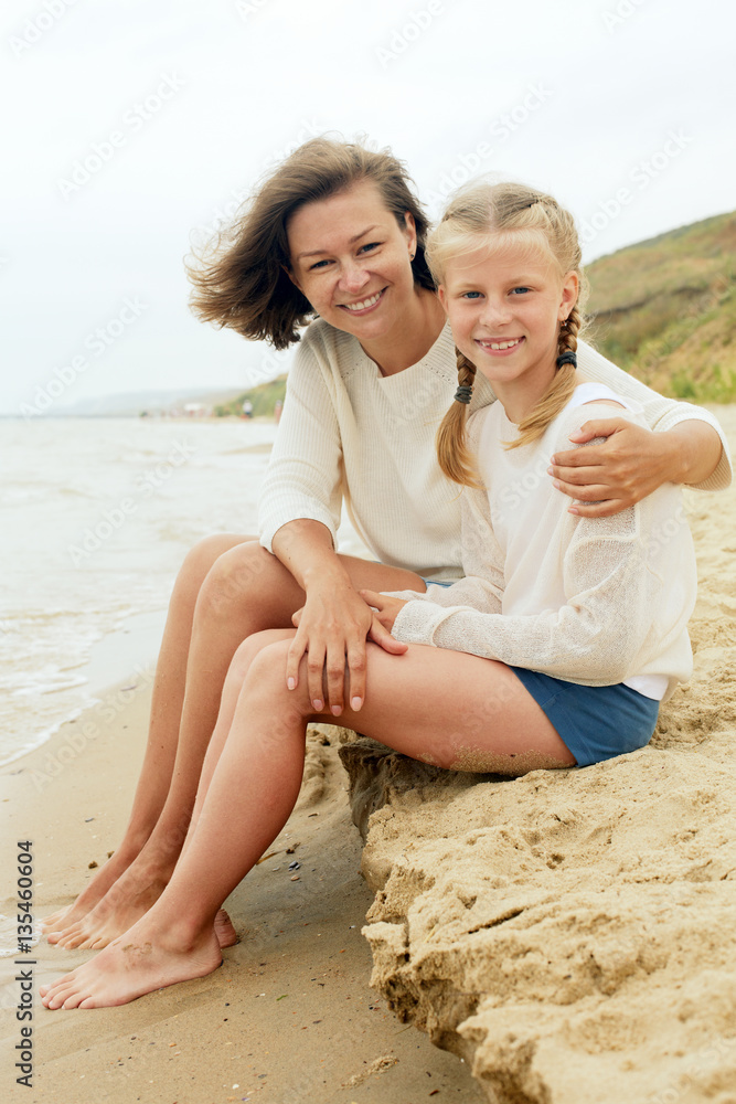 Happy family resting on a sandy beach Happy family resting on a sandy beach
