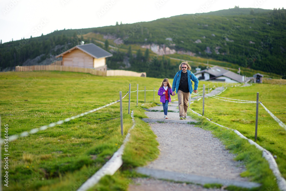 Father ond his little daughter hiking in South Tyrol, Renon/Ritten region, Italy. Beautiful Alpine village on a background. Father ond his little daughter hiking in South Tyrol, Renon/Ritten region, Italy. Beautiful Alpine village on a background.