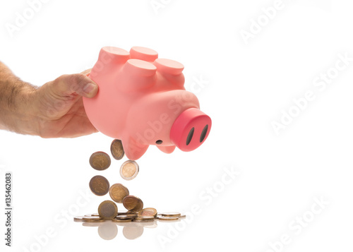 emptying piggy bank with euro, isolated on white photo