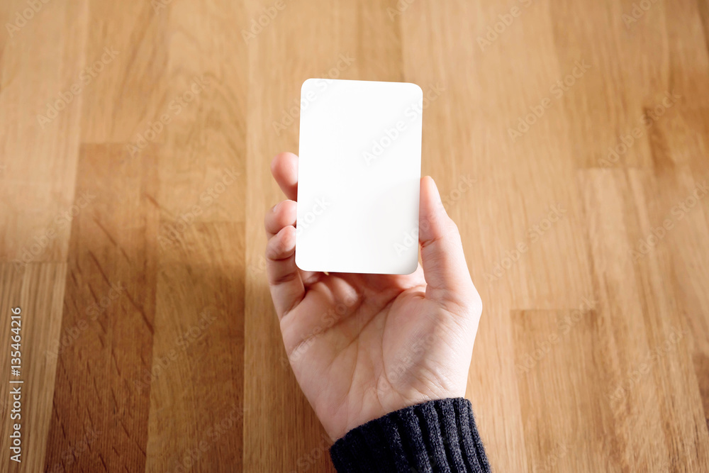 Woman holding blank business card Woman holding blank business card