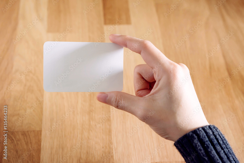 Woman holding blank business card Woman holding blank business card