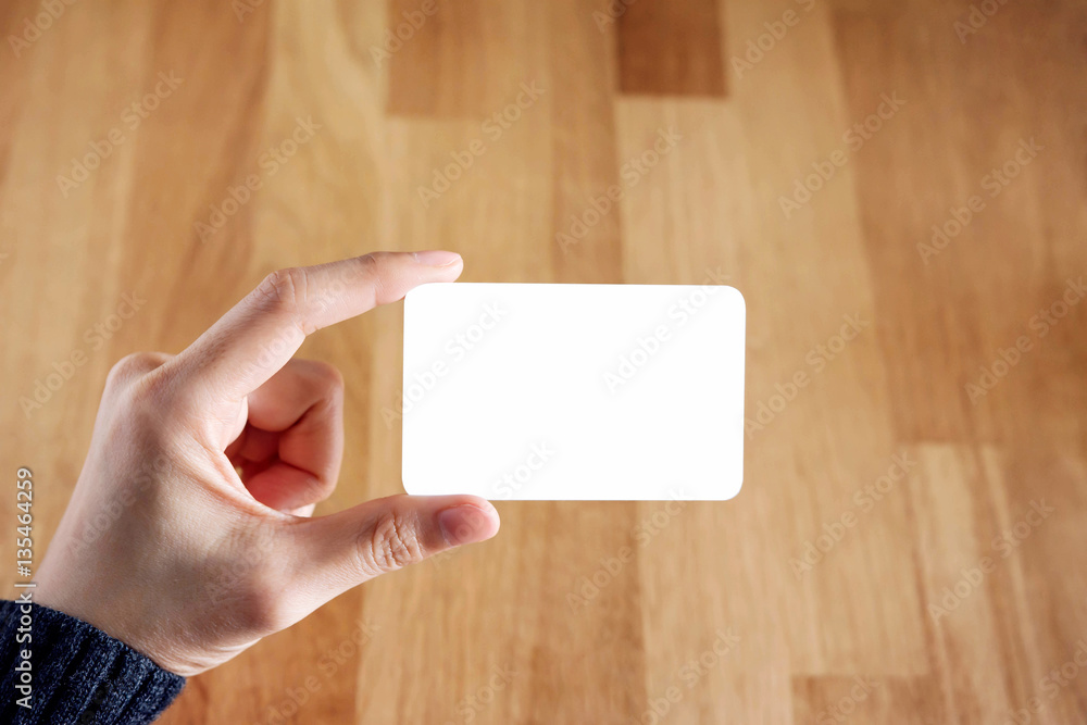 Woman holding blank business card Woman holding blank business card