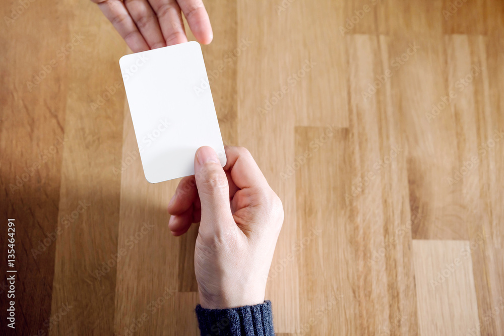 Woman holding blank business card Woman holding blank business card