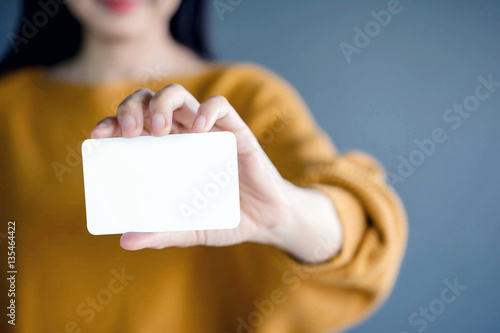 Woman holding blank business card. White Paper Card for Mockup
