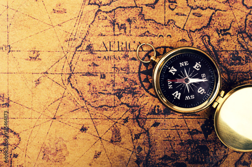 compass on old vintage world map with copy space