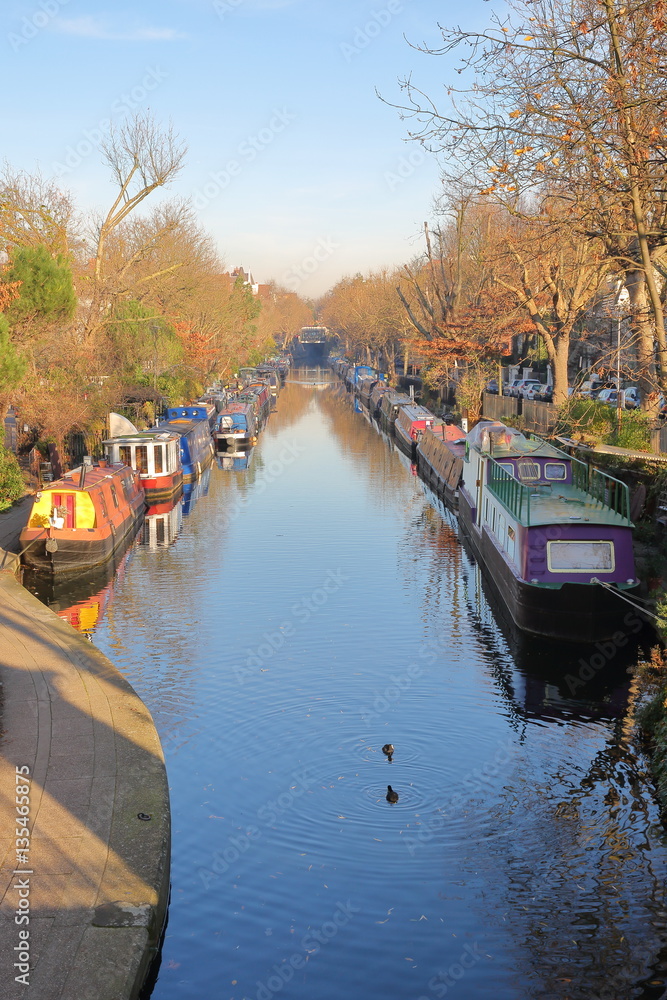 LONDON, UK: Reflections in Little Venice with colorful barges along canals LONDON, UK: Reflections in Little Venice with colorful barges along canals