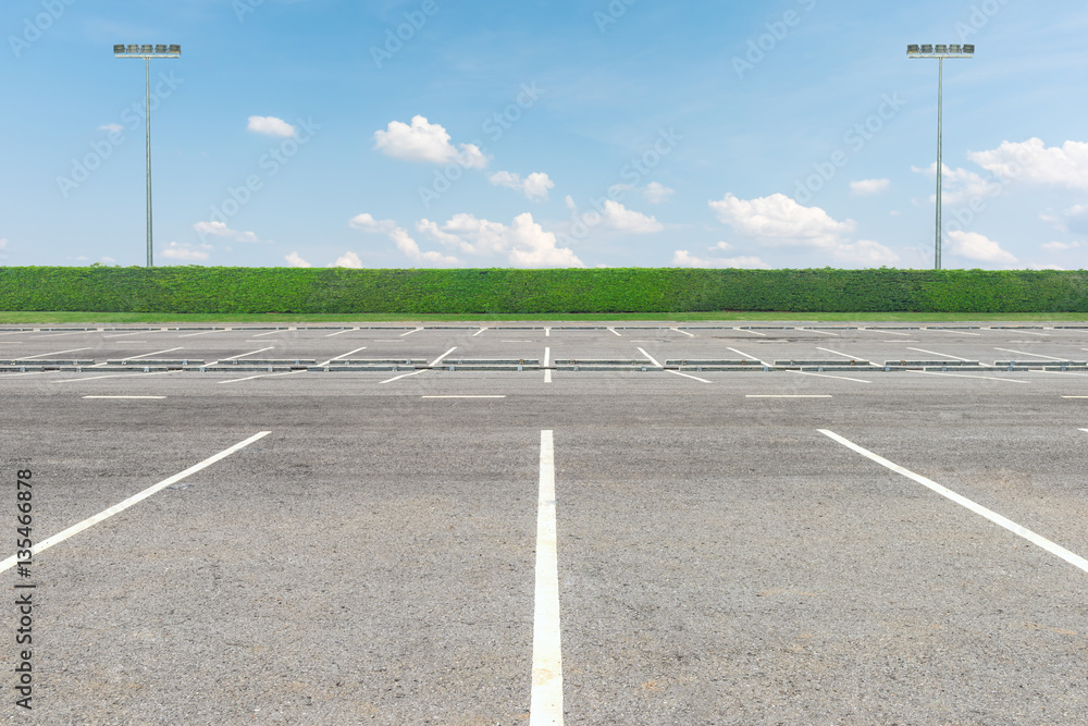 Fototapeta premium Empty parking lot against a beautiful blue sky