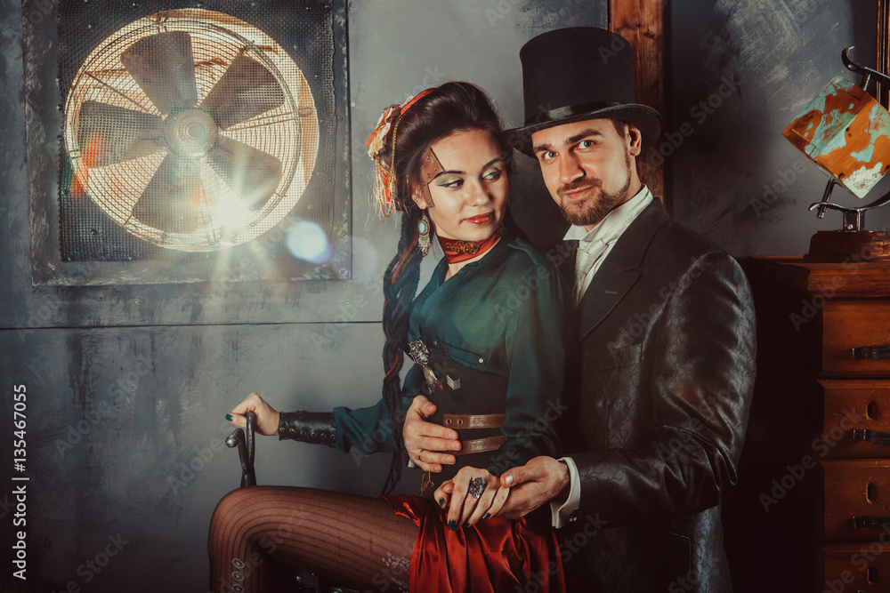 Obraz premium Pretty flirting couple dressed in vintage costumes on the dark room background.