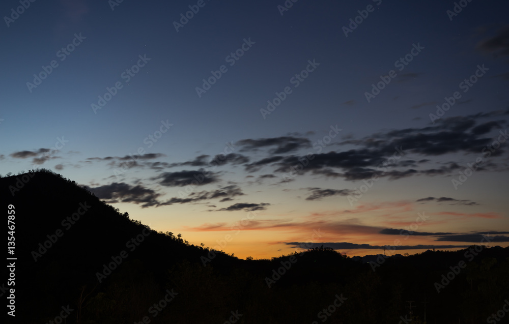 Sunset with mountain silhouette Sunset with mountain silhouette