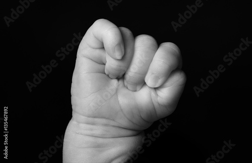 One hand the newborn, close up