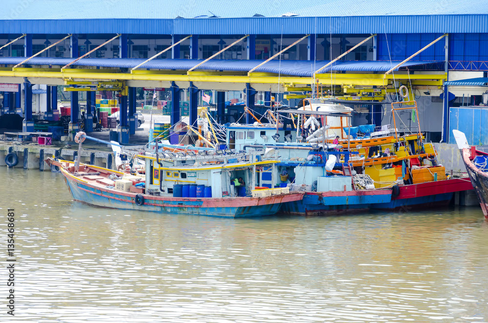 JOHOR, MALAYSIA - JANUARY 30, 2017: Fishing boats anchored at the jetty during the monsoon season at Endau, Johor, Malaysia. Endau is one of the most important fisheries in Johor.