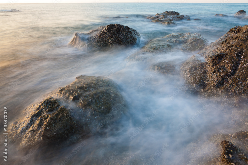 Waves and rocks shore long exposure